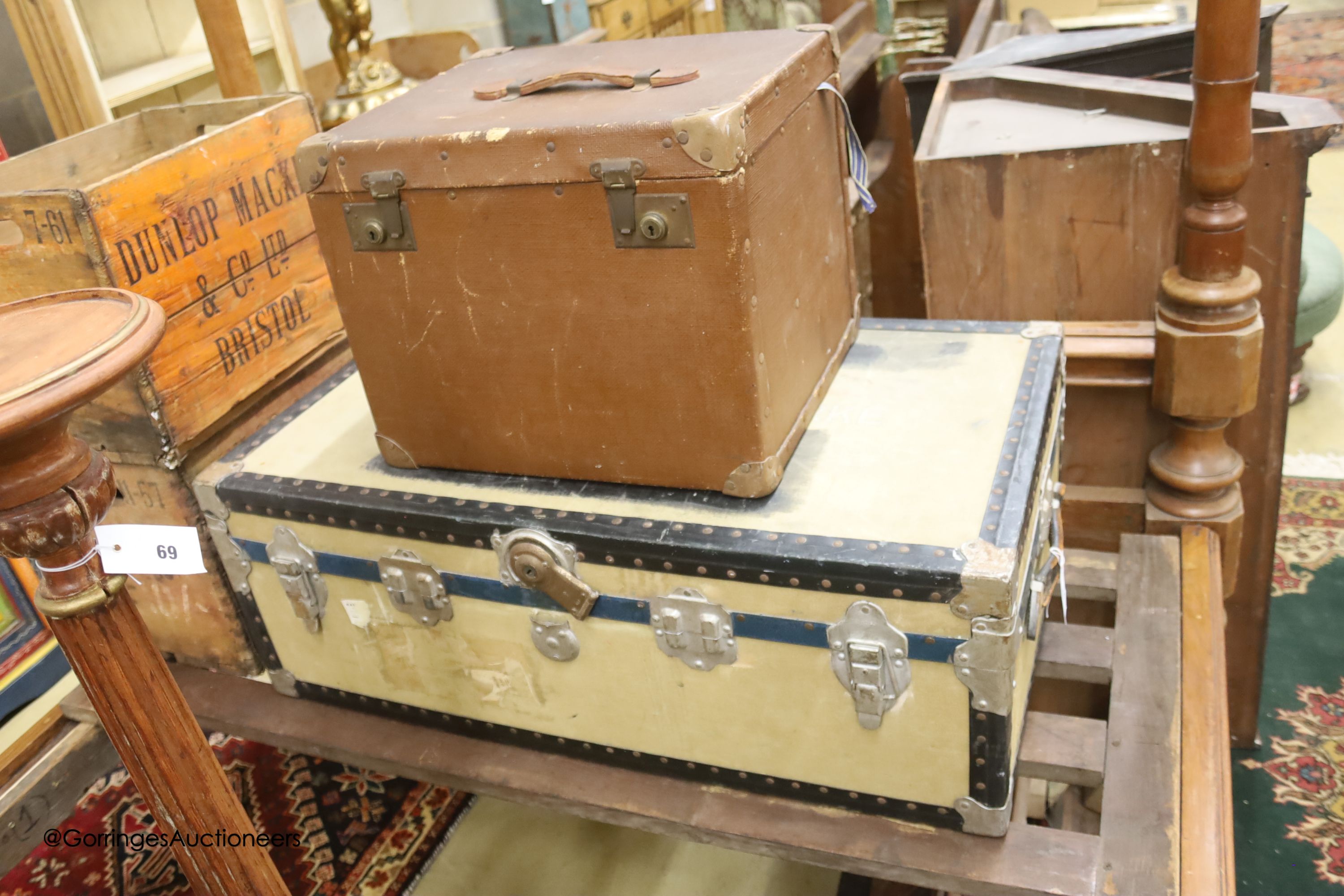 A Victorian tan leather and canvas domed top trunk, width 76cm, depth 60cm high together with two suitcases